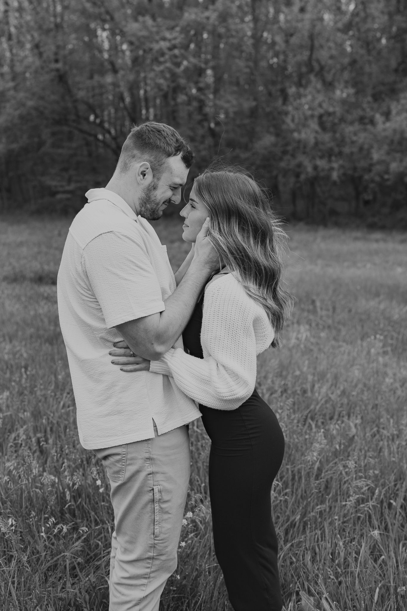 Black and white photo series of couple sharing tender moments in a field. Couple photography done in southern Michigan.