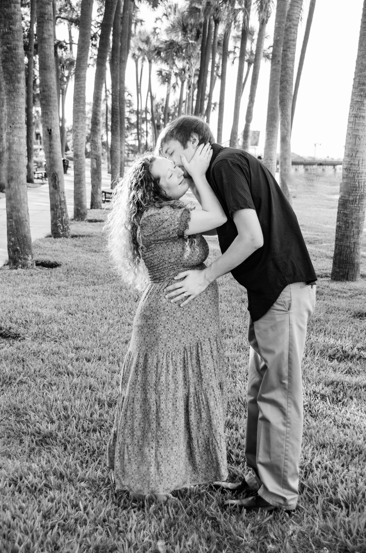 Husband and Wife maternity photos with palm trees at Univ. of Tampa