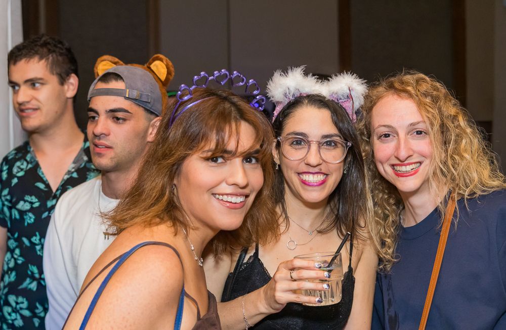 A group of people socializing and enjoying drinks at what appears to be a party or gathering.