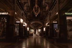 Intimate couples portrait at night at the Manchester museum. couple embracing on the stairs
