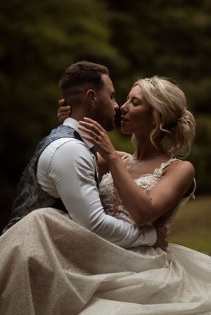 intimate portrait of a bride and groom embracing on their wedding day. Bride reaching up to hold the grooms neck.