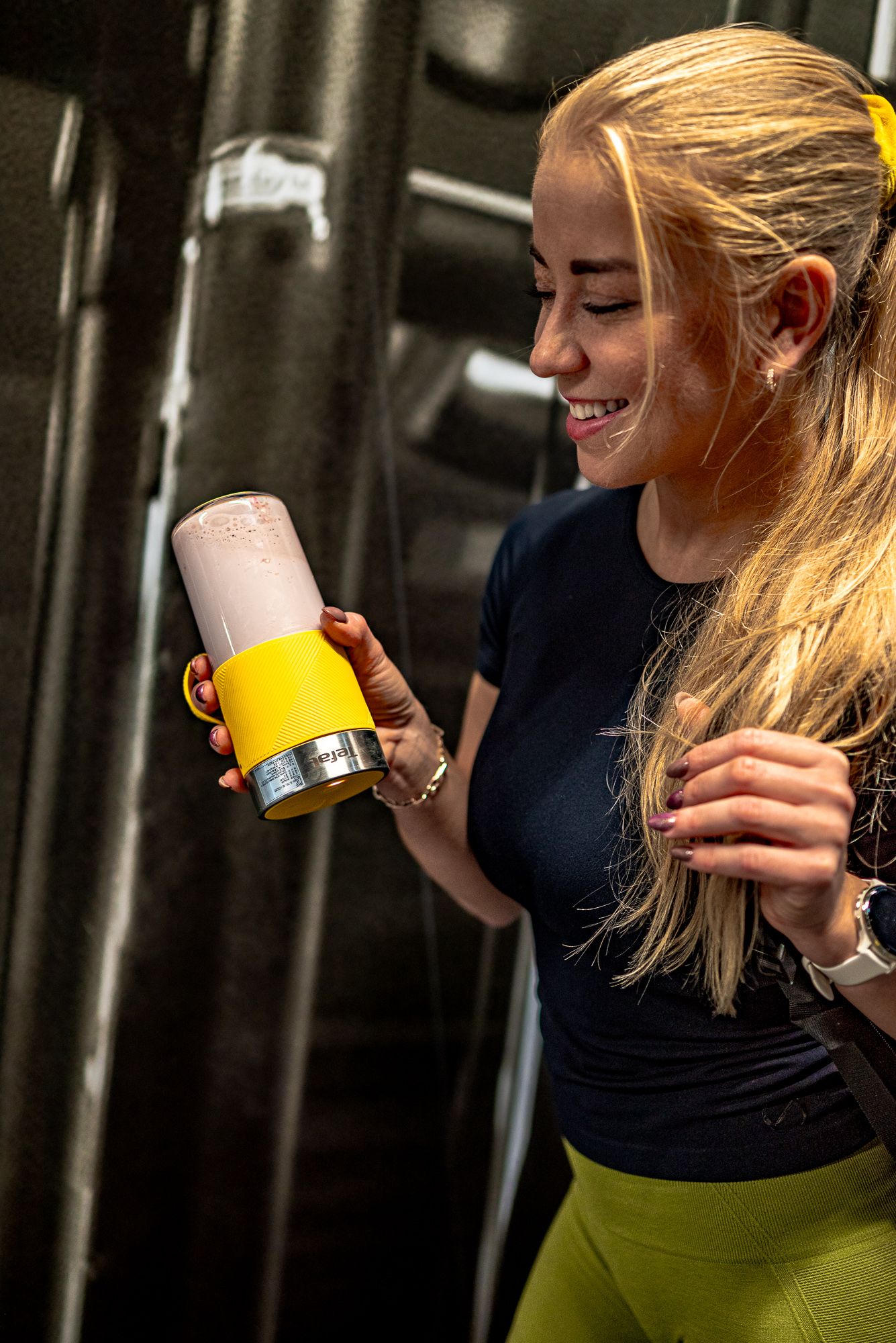 Person in black shirt drinking from yellow and pink cups shown in sequence of progressive drinking motions.