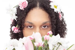 Beautiful natural floral portrait with pink carnations and white daisies framing against white background.