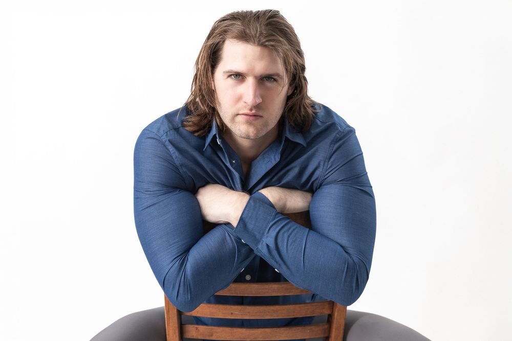 Three photos of someone wearing a navy blue sweater posing with crossed arms against a white backdrop.