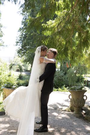 Cora Emilie Media Wedding couple embraces in multiple romantic poses beneath drooping garden trees.