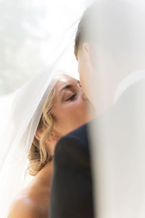 Cora Emilie Media Soft focus close-up shot of a bride's profile through her delicate veil.
