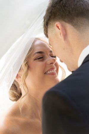 Cora Emilie Media Close-up wedding portrait showing tender moments between newlyweds.
