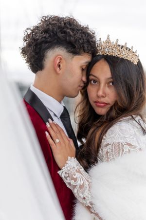 Cora Emilie Media -Intimate wedding portrait showcasing a couple in burgundy velvet and white lace with a delicate crown.