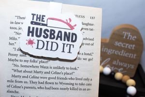 Close-up of book pages with decorative stickers and text about a husband.