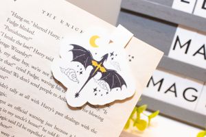 Book pages decorated with small stickers and tabs showing text snippets.