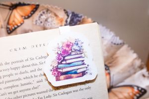Open book pages with butterfly stickers and decorative elements.