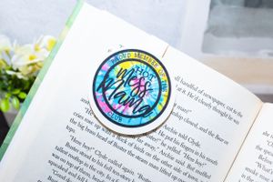 Open book pages with colorful circular stickers and text visible.