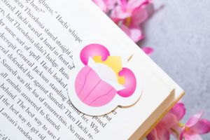 Book pages decorated with pink heart stickers and floral elements.