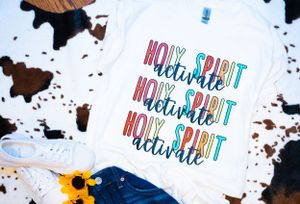 Collection of t-shirts featuring colorful Holy Spirit text designs.