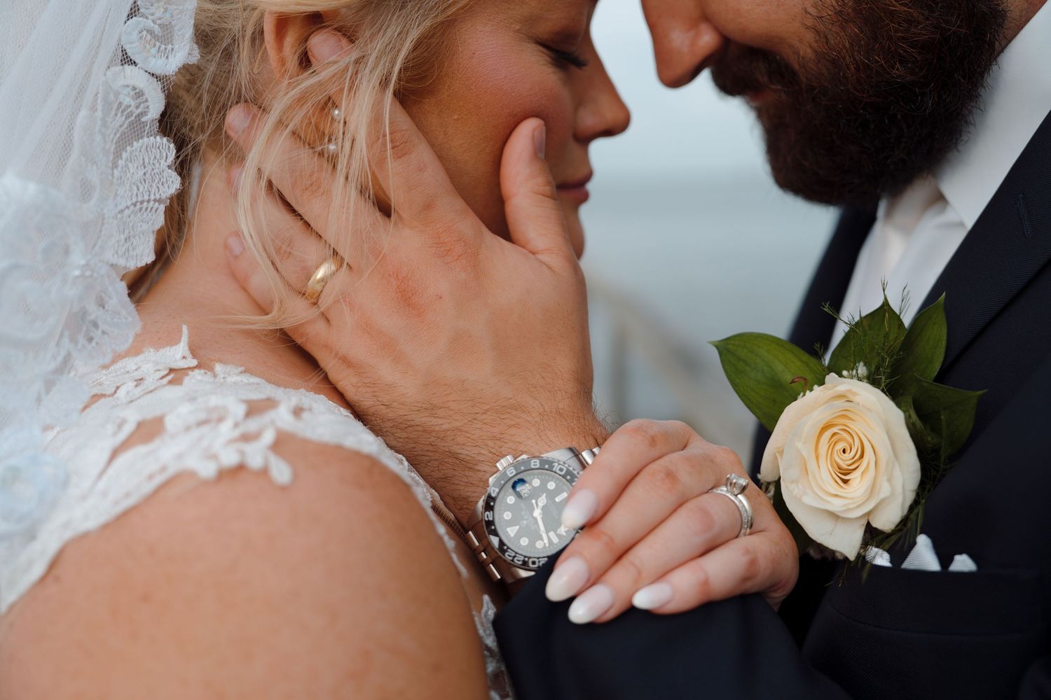 Elegant white rose and baby's breath bouquet arranged in front of a glowing fireplace creating a romantic ambiance.
