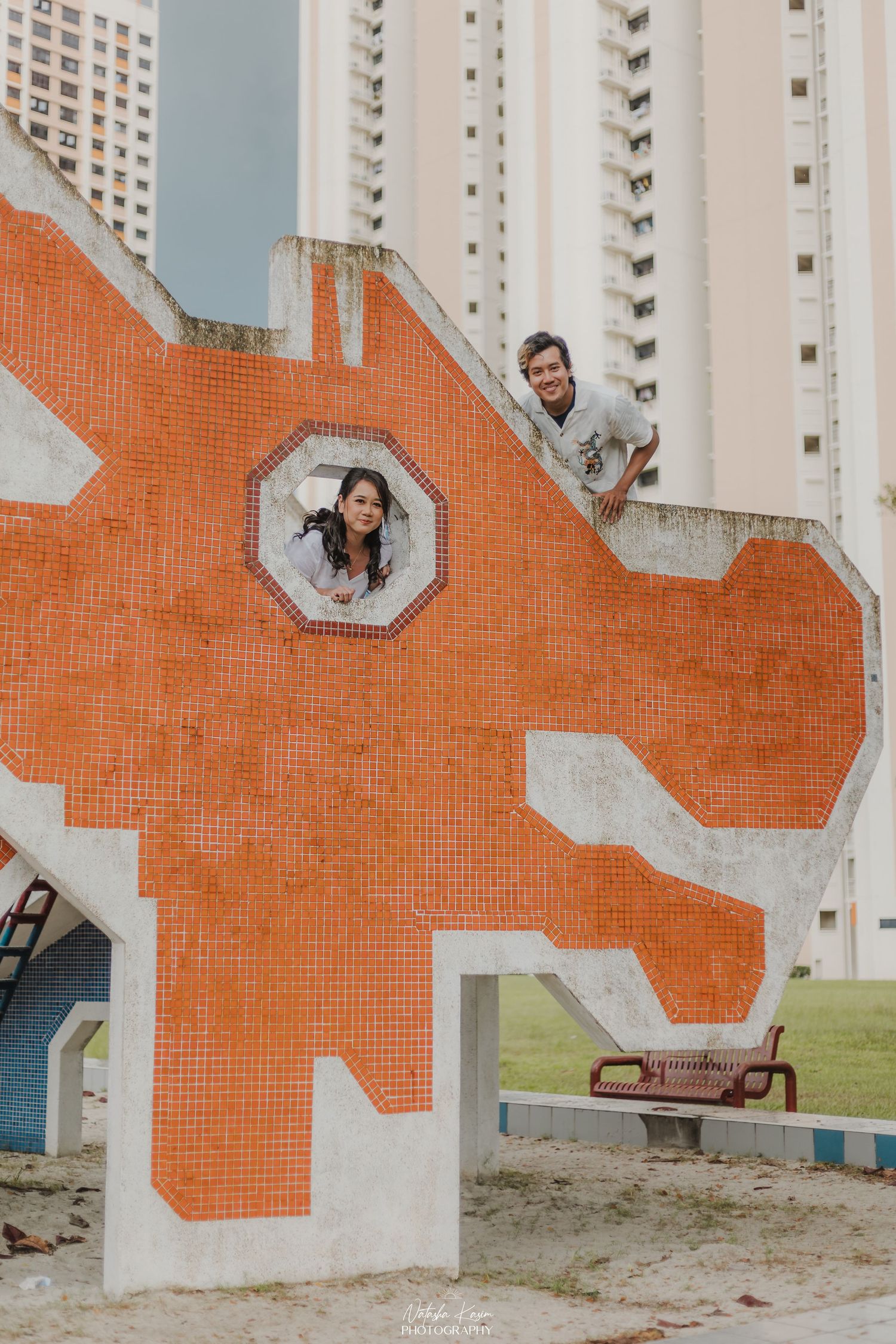 Vintage style photography session in front of colorful heritage shophouses with ornate details.