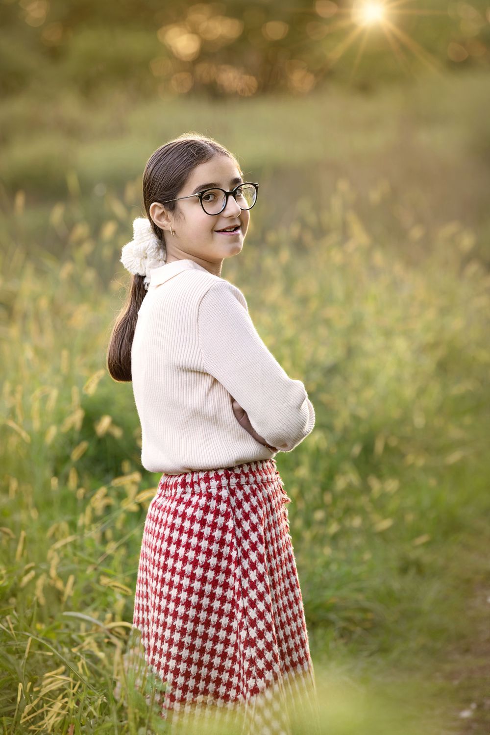 A collage shows someone in glasses and white sweater with red checkered skirt outdoors during golden hour.