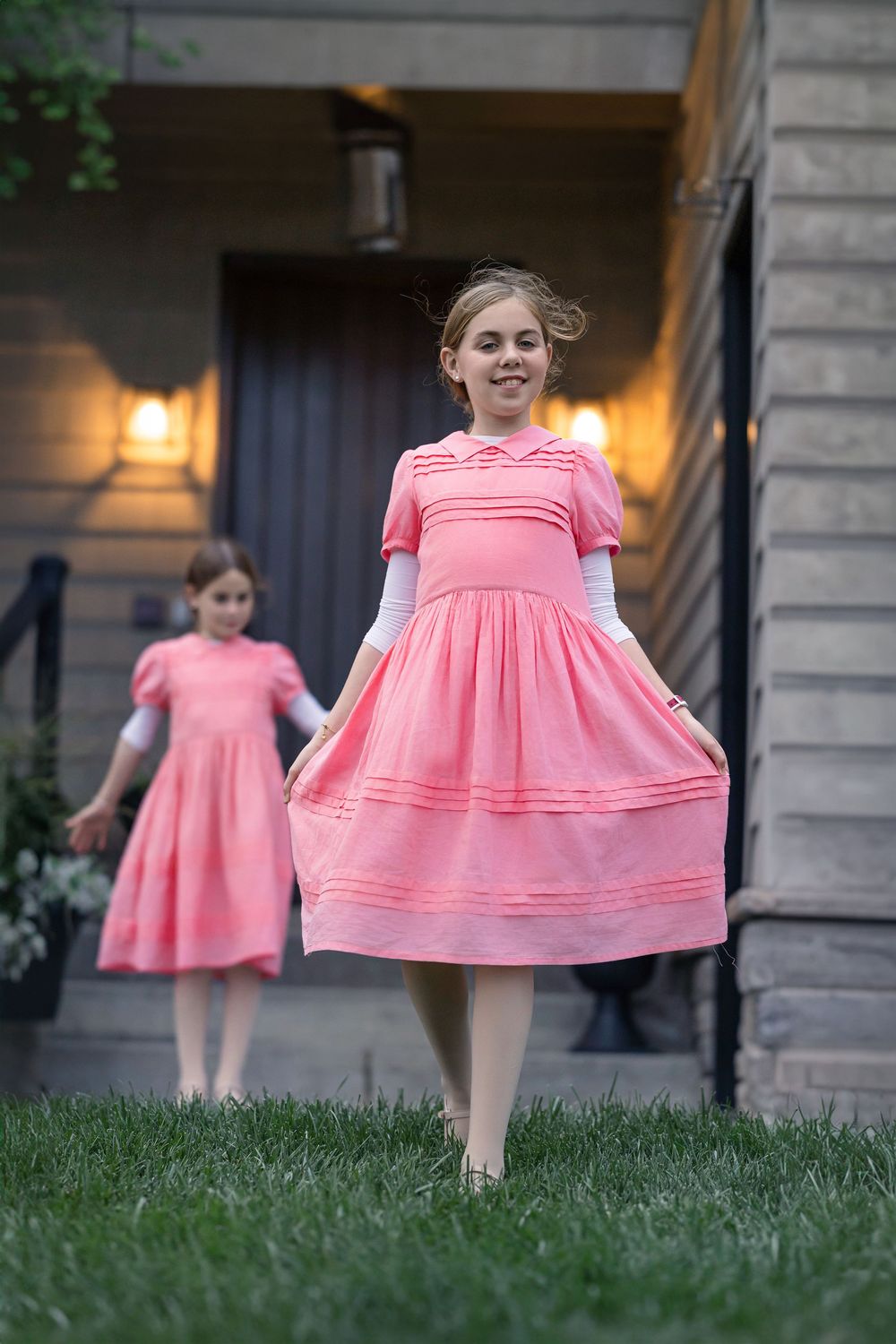 A series of photos showing a twirling pink dress against a stone building exterior and grass lawn in golden light.
