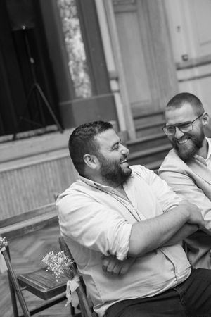 Friends sharing laughter and conversation at an outdoor gathering.
