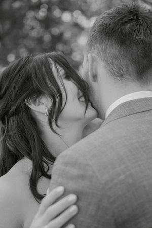 An intimate black and white close-up moment captured during a special occasion.