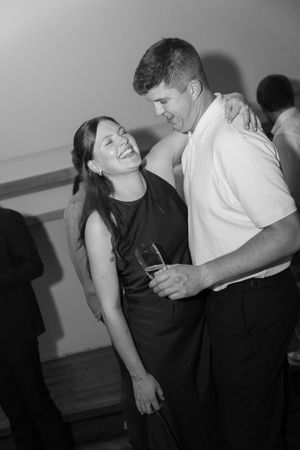 Couples dancing and enjoying themselves at a party in black and white.