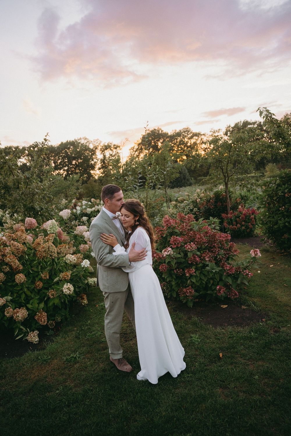 Romantic sunset moment in a blooming garden with roses and greenery.