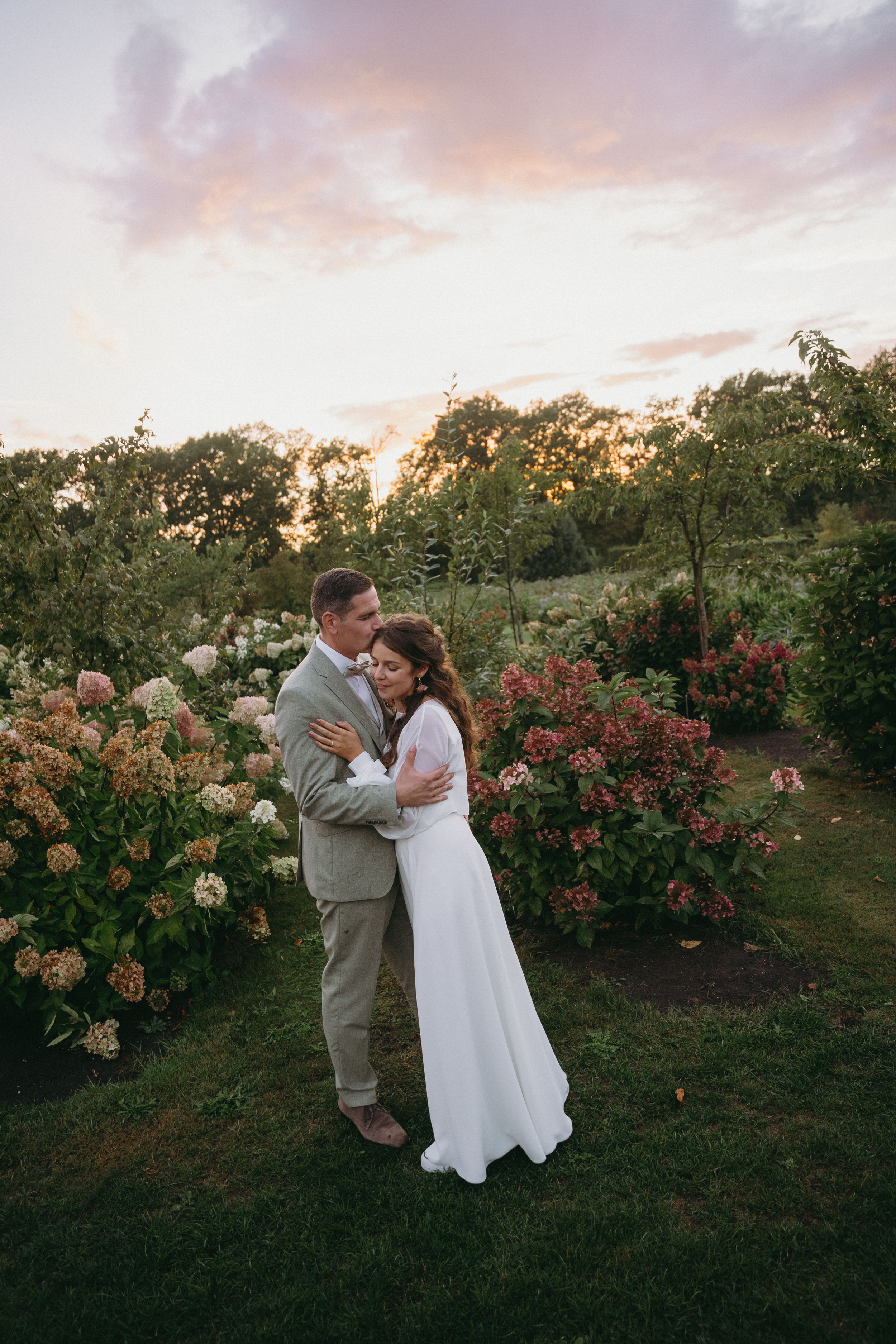 Romantic sunset moment in a blooming garden with roses and greenery.
