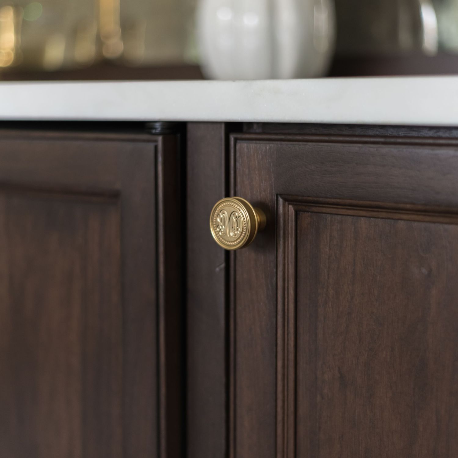 Close-up view of dark wood cabinet edges and hardware showing fine carpentry details and craftsmanship.
