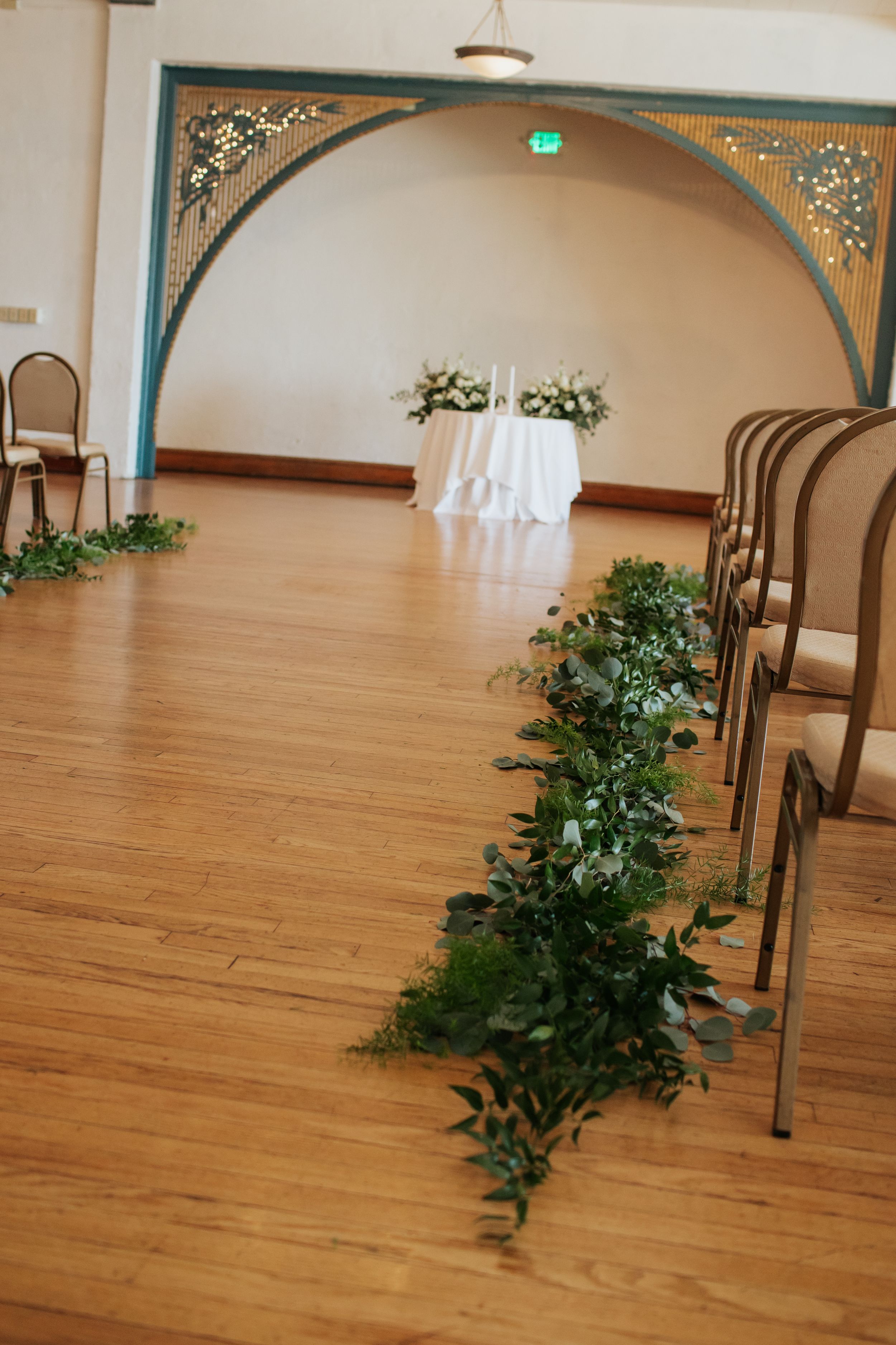 A series of five connected photos showing a hardwood dance floor with decorative arches and potted plants along the wall.