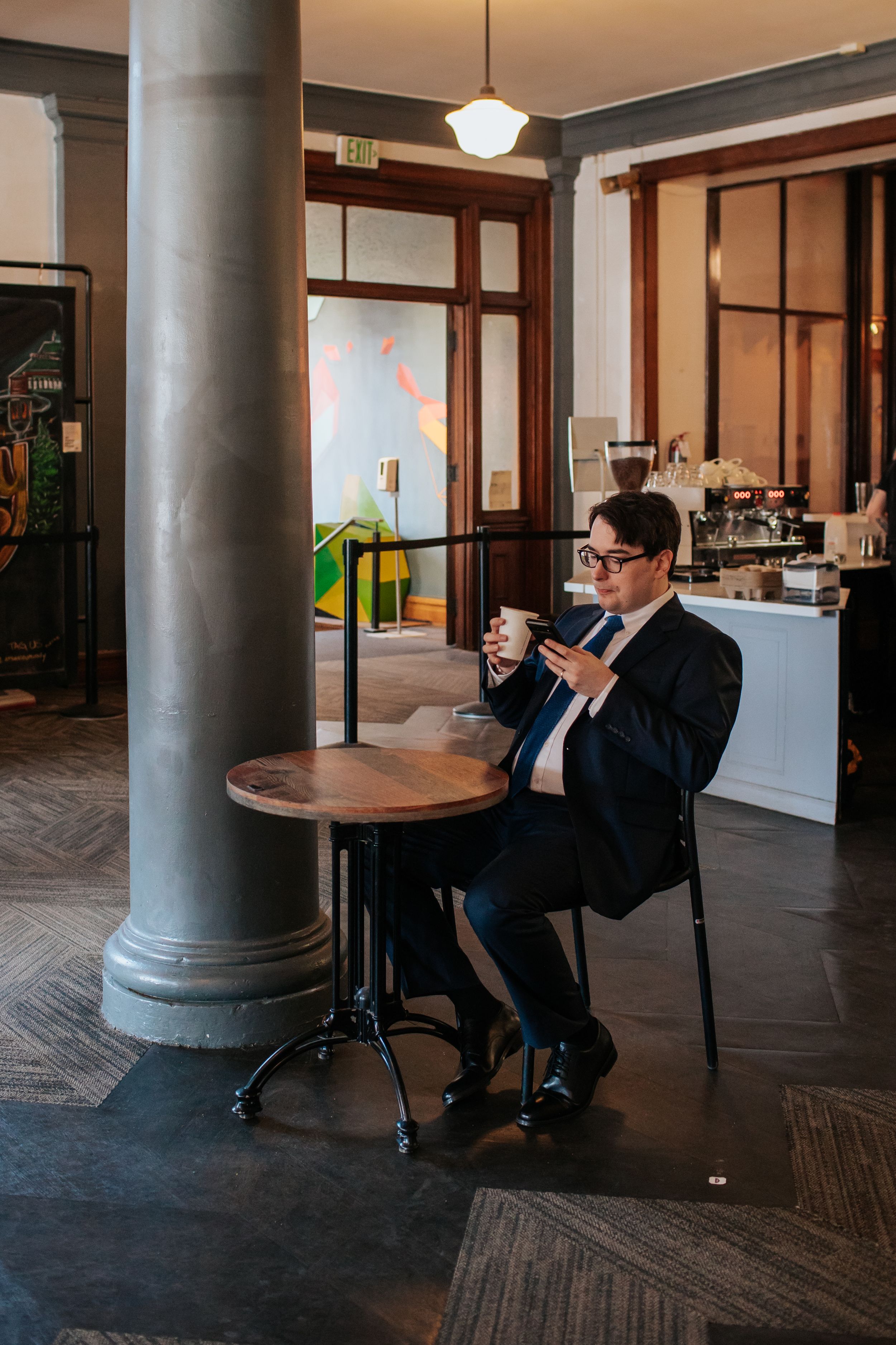 A sequence of four photos showing a person in business attire sitting in a chair against a column in an elegant interior space.