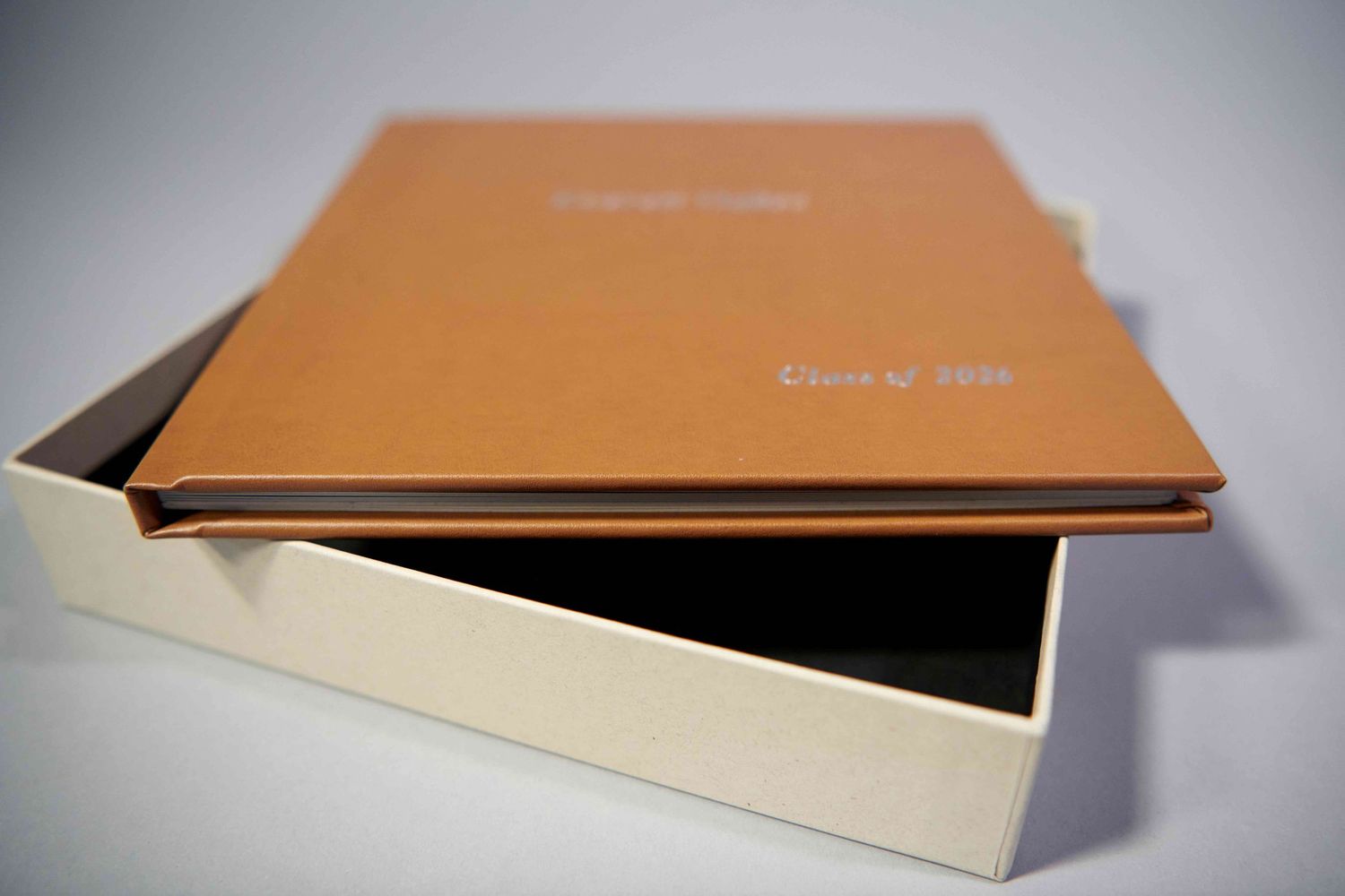 High school "Memory" album in honey leatherette.  Album resting on side to show thickness of cover, overall thickness of album, and box.