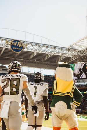 Row of football players' jerseys lined up showing uniform numbers and team branding.