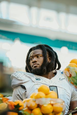 Athletes enjoying fresh oranges during a break at a football game.