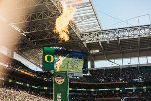 Wide angle view of football stadium with retractable roof and team banners.