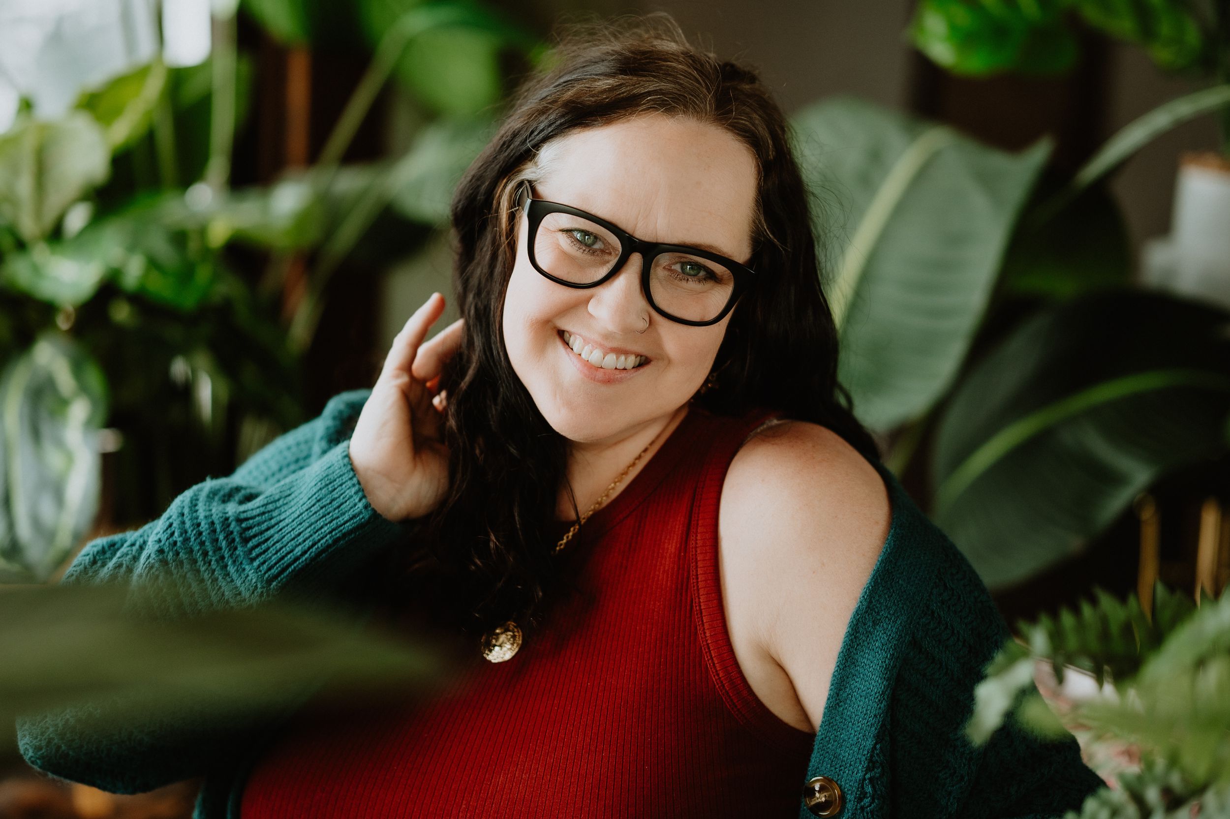 A series of photos showing someone in a red top posing in a lush garden setting with tropical plants.