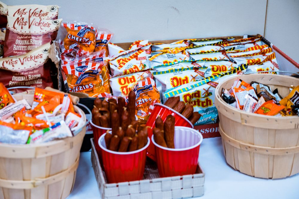 Rustic wooden baskets filled with colorful candy and snack assortments arranged in a festive display.