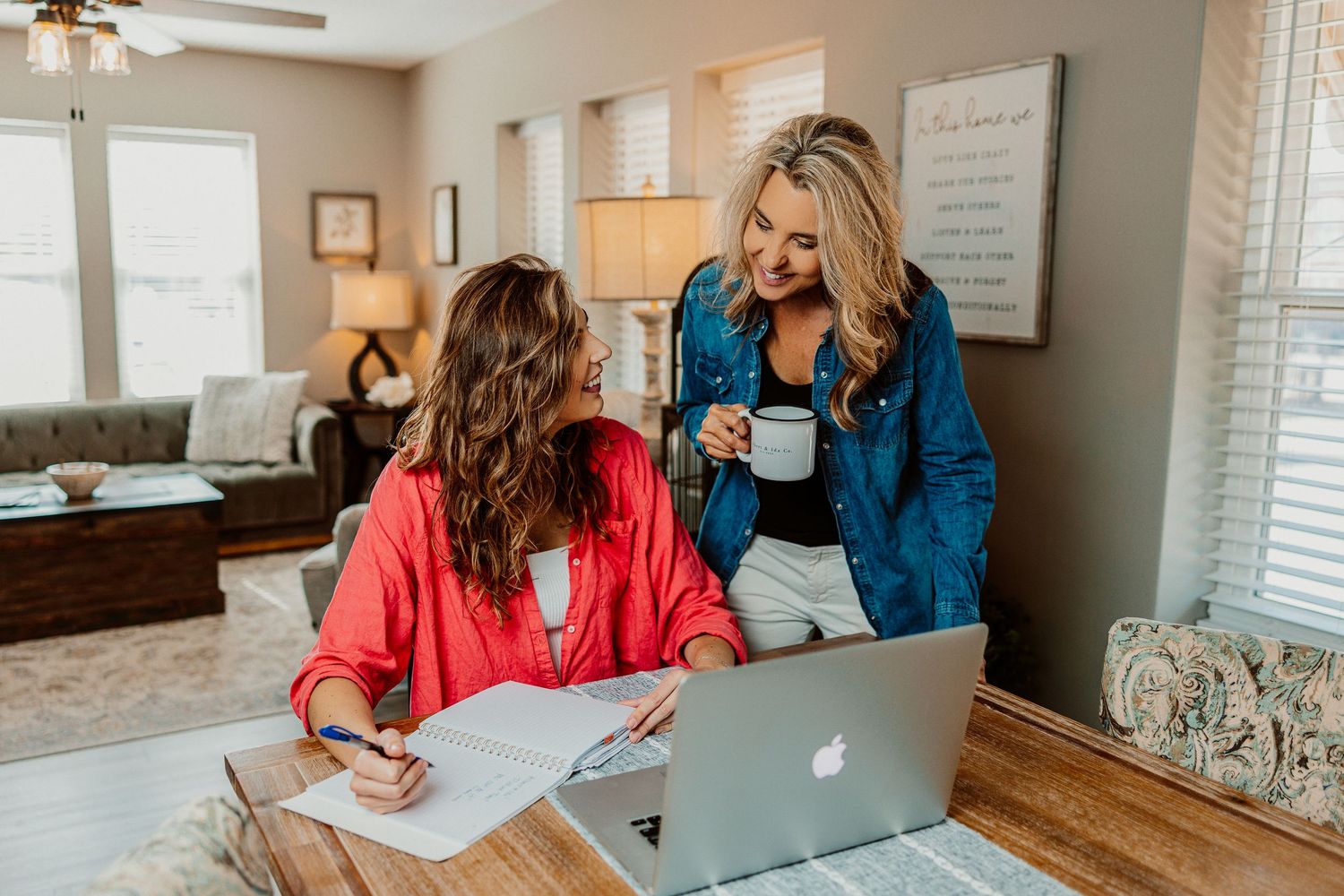 Business professionals collaborate at a desk with laptops and paperwork in a bright modern office in Paola, Kansas
