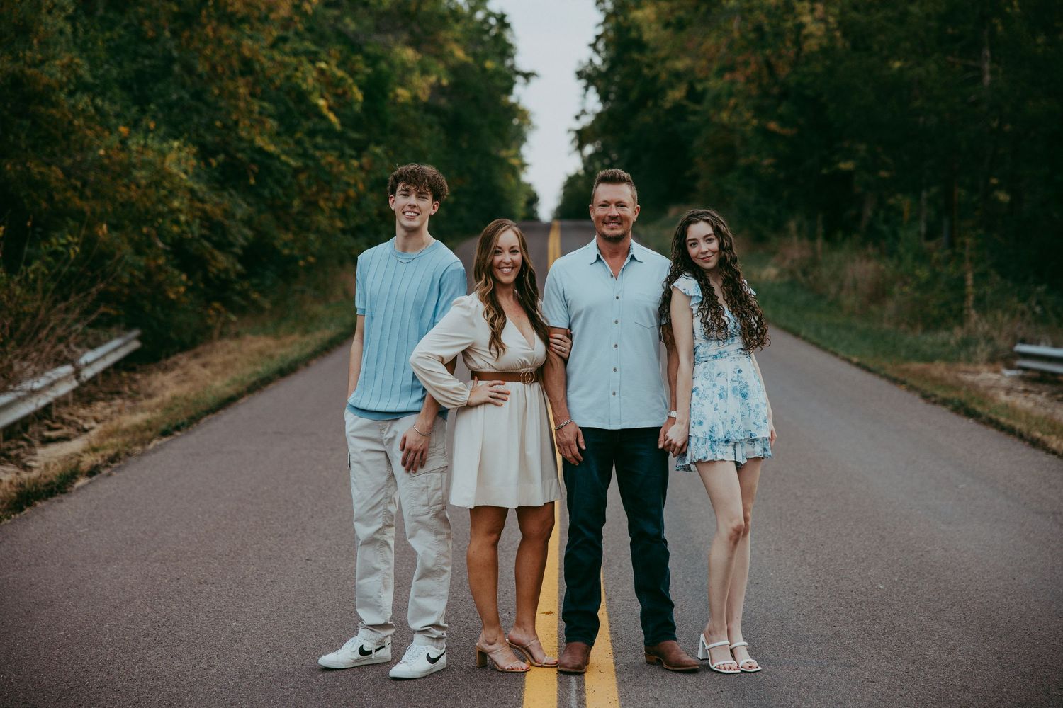 Family portraits on tree-lined path during Spring Hill, Kansas autumn photo session.