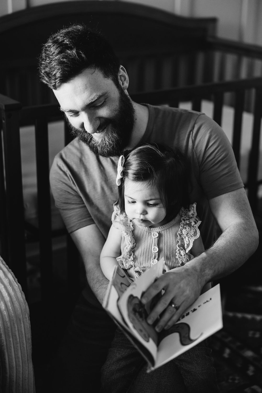 Black and white series of intimate moments showing parent and child reading together in cozy indoor setting.
