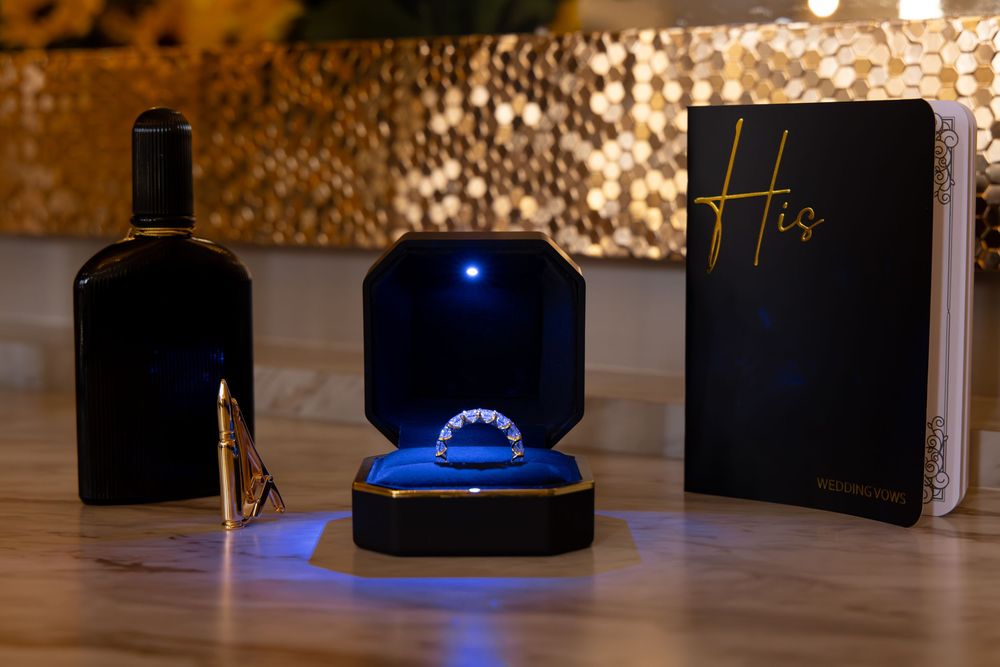 A row of black electronic devices with blue LED lights displayed on a dark wooden surface.