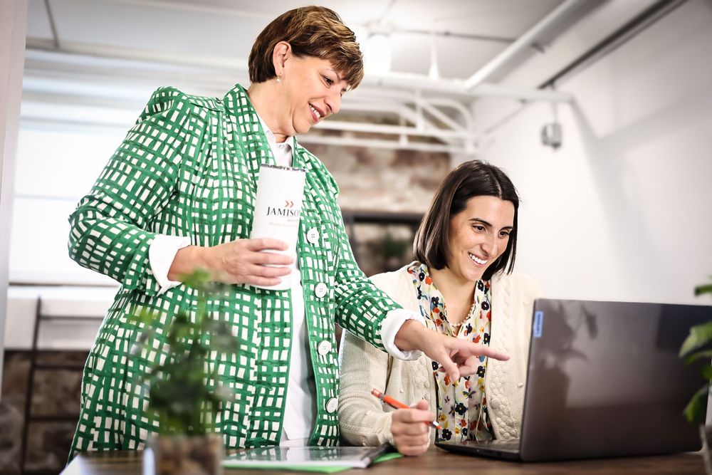 Office lifestyle photos showing people working at desk with green patterned clothing.