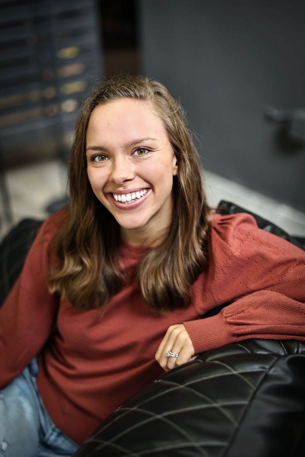 Relaxed lifestyle portraits in a burgundy sweater showing genuine expressions.
