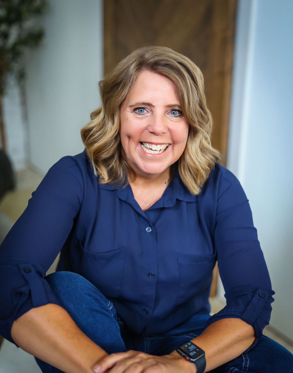 Professional headshots in navy blue top against light background.