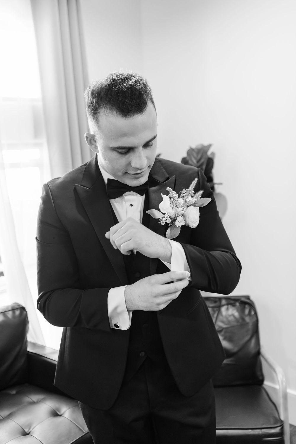 Series of black and white photos showing someone in a tuxedo smelling a boutonniere flower on their lapel.