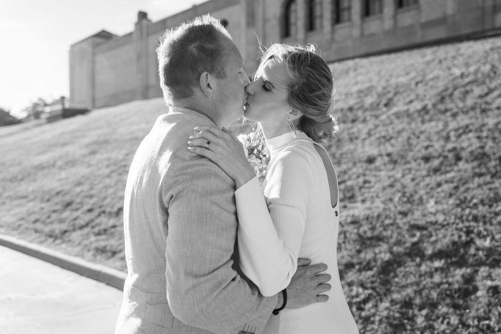 A romantic couple shares tender moments in a series of black and white outdoor photographs.