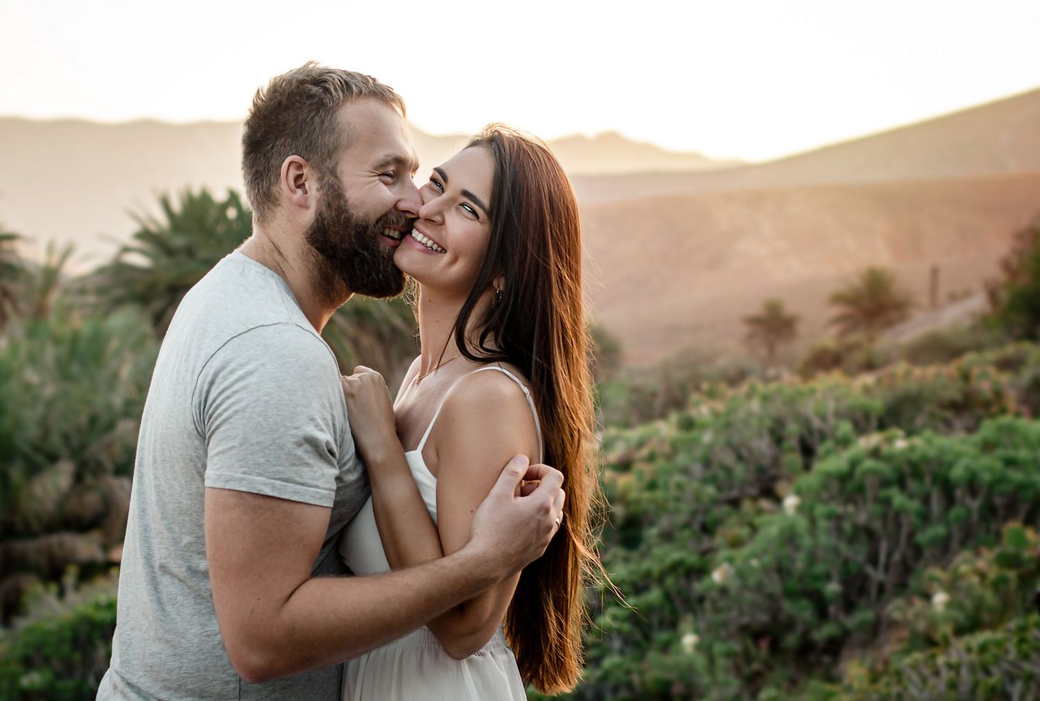 Couple sharing a laugh during a golden hour session in the Betancuria mountains - photoFuerte portraits