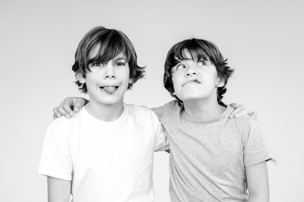 Sibling silly black and white portrait for family wall art in Chicago North Shore