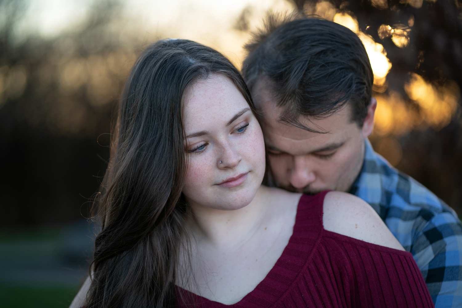 A romantic couple shares an intimate kiss  during their engagement session