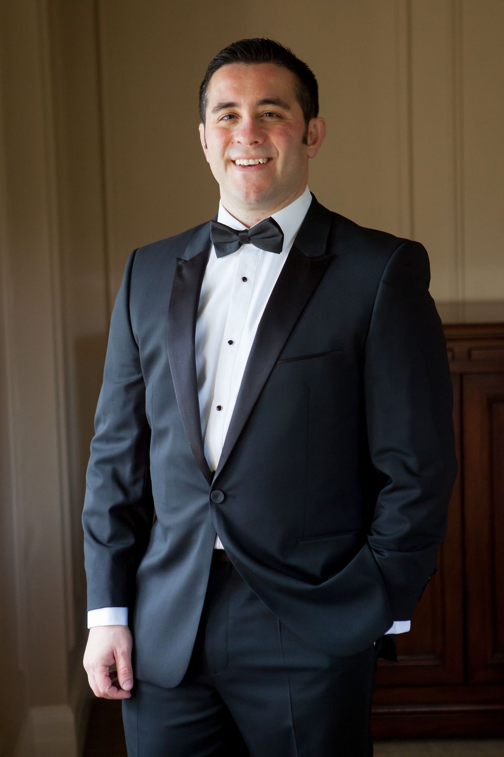 Formal black tuxedo with bow tie and white shirt displayed in multiple angles.
