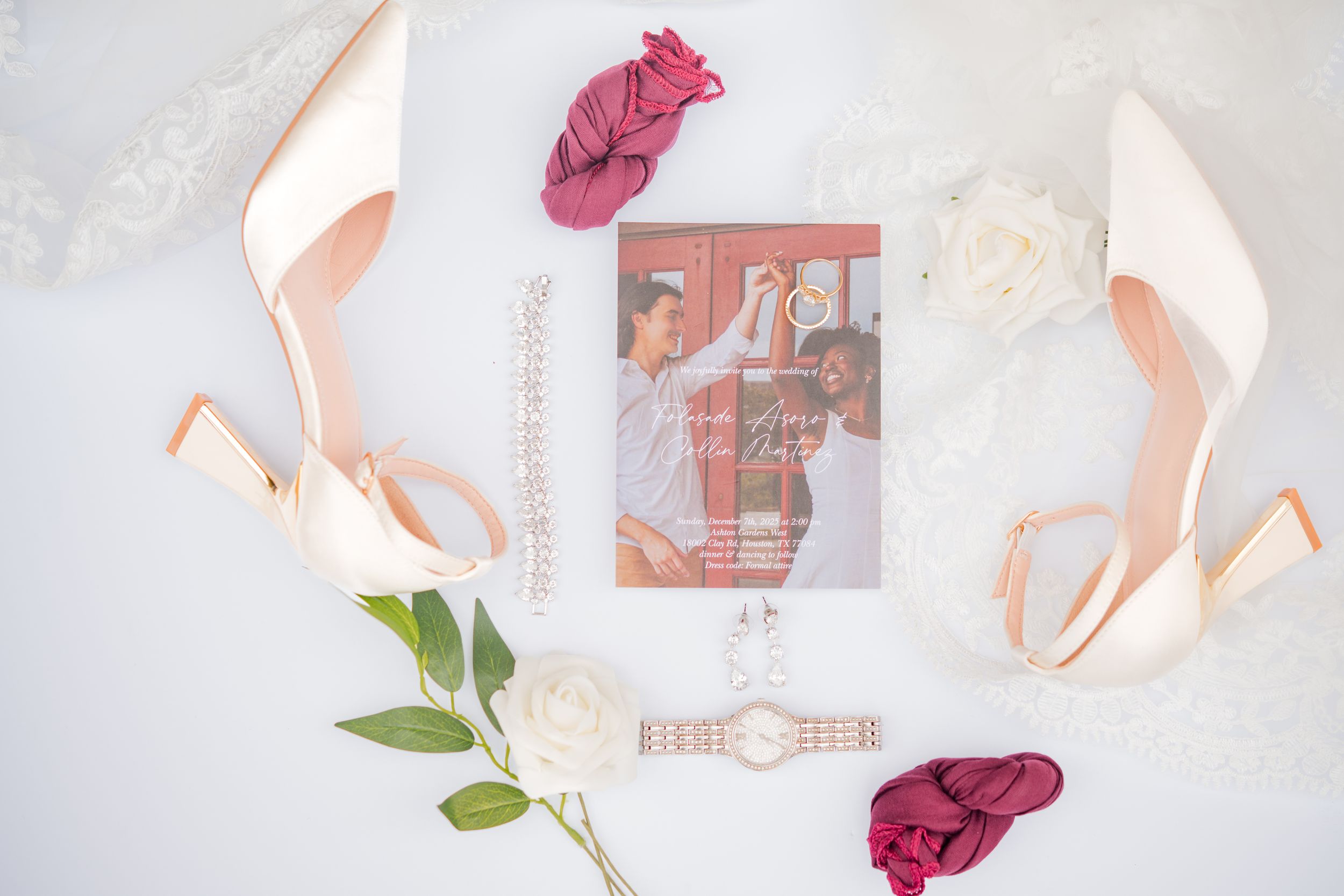 A pink ballet slipper and rose petals arranged artistically on a white background with soft lighting.